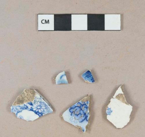 Blue transfer printed whiteware rim sherd; blue transfer printed whiteware body sherd; blue hand painted pearlware body sherd; blue transfer printed pearlware body sherds