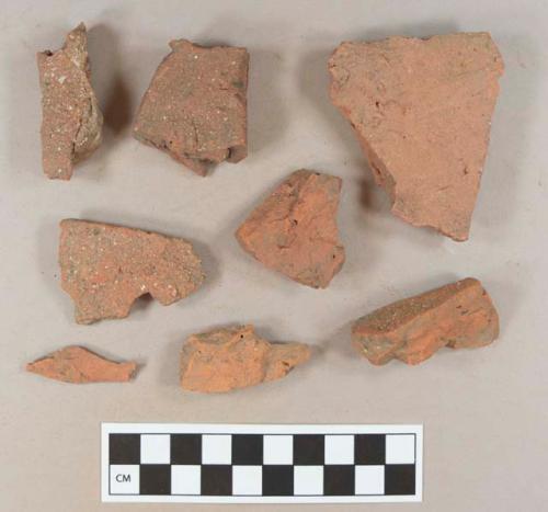 Redware roof tile fragments, two with nail holes; brick fragments