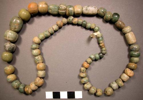 Ground stone; beads; discoidal, tubular & round - several incised; strung togeth