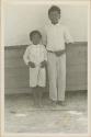 Two young boys posing for photograph