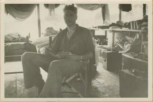 Henry Roberts sitting in a chair reading