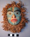 Painted wooden miniature mask with shredded cedar bark backing