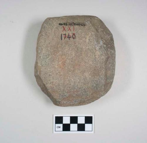 Palette-abrading stone. ovoid block. 1 flat worn smooth face, red pigment?; othe