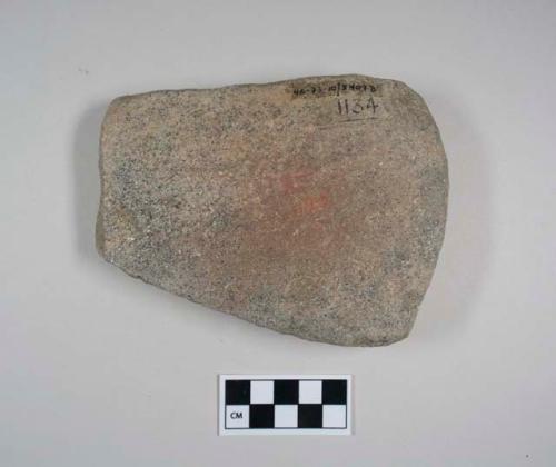 Abrading stone-pallette. block. part of periphery pecked, rounded. 1 slightly co