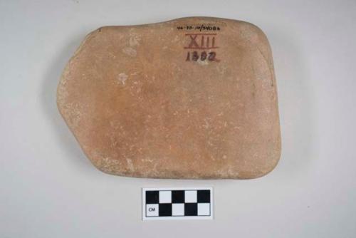 Abrading stone, possible pallette. rectangular, flat cobble. 1 flat face particu