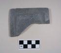 Palette end fragment. remnant of rectangular palette. raised border with incised