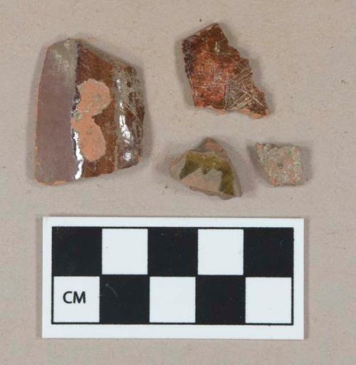 Undecorated lead glazed redware body sherds; slip decorated lead glazed redware body sherd; brick fragment