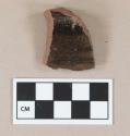 Redware body sherd, with lead glaze on one side and incised lines on the other