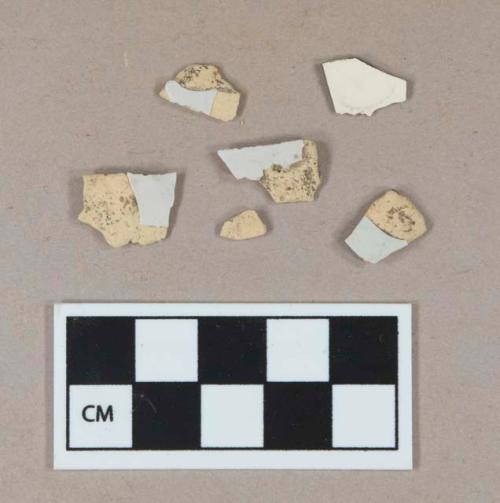 Undecorated tin glaze earthenware body sherds; tin glaze earthenware body sherd, missing all glaze; undecorated creamware body sherd