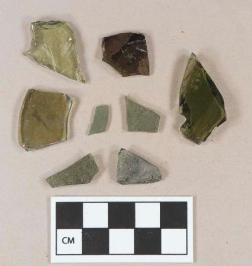 Olive green bottle glass fragments; olive green flat glass fragment