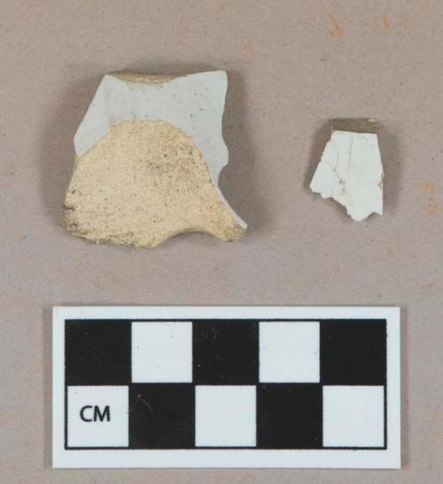 Undecorated whiteware body sherd; undecorated tin glaze earthenware body sherd