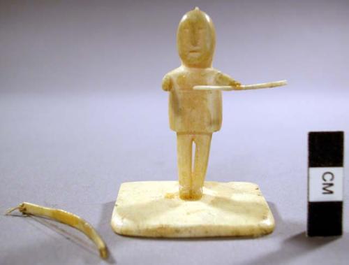 Ivory carving of a man with bow and arrow