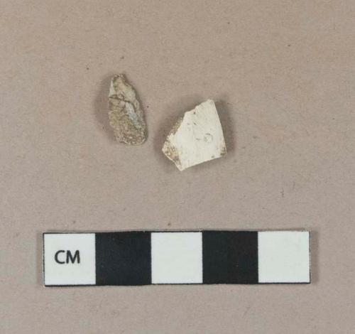 Smoked, undecorated pipe bowl fragment; clinker fragment