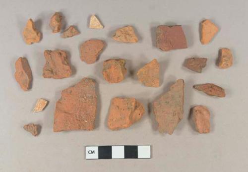 Brick fragments; unglazed, undecorated redware body sherds