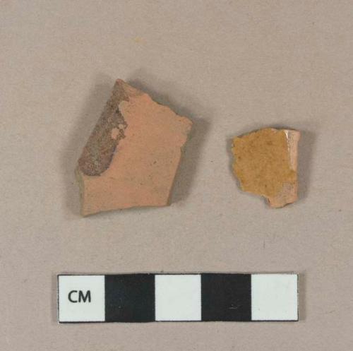 Undecorated lead glazed redware body sherd; slip decorated lead glazed redware body sherd