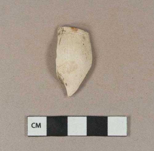 Smoked pipe bowl fragment with incised lines around the rim