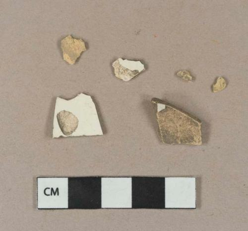 Undecorated creamware body sherds; undecorated tin glaze earthenware body sherd; tin glaze earthenware body sherds, missing all glaze