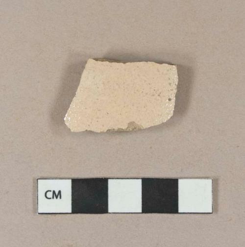 Buff salt glazed stoneware body sherd with albany slipped interior