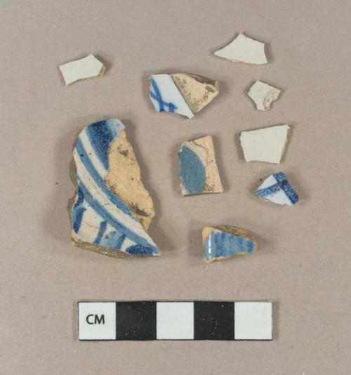 Blue hand painted tin glaze earthenware body sherds; blue hand painted tin glaze earthenware base sherd; undecorated tin glaze earthenware body sherds