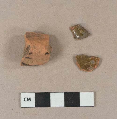 Undecorated lead glazed redware body sherds; undecorated lead glazed redware rim sherd