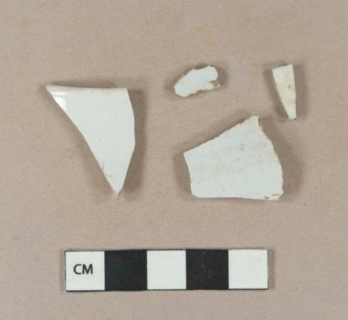 Undecorated porcelain body sherd; undecorated ironstone body sherds; undecorated ironstone rim sherd