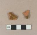 Undecorated lead glazed redware body sherds; two sherds crossmend