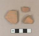 Undecorated, unglazed redware vessel body, base, and rim fragments, possibly terracotta