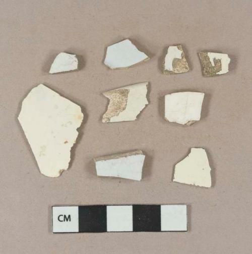 Undecorated creamware vessel body fragments, light buff paste; 3 undecorated whiteware fragments white paste; 2 undecorated white ironstone vessel body fragments, white paste