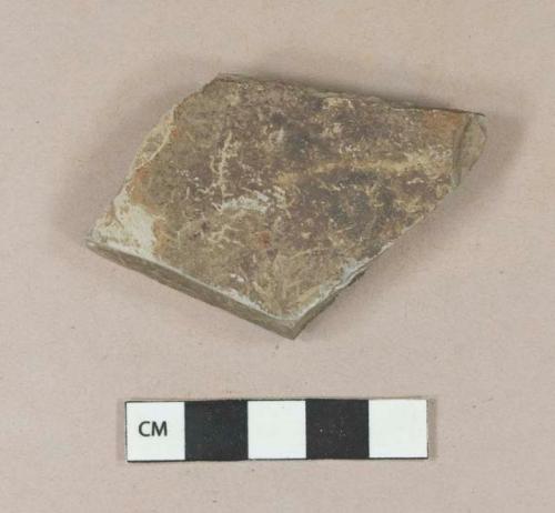 Dark gray mudstone fragment, possibly architectural