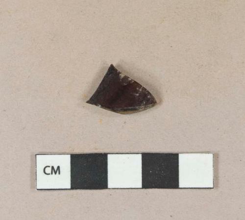 Dark amber vessel glass body fragment