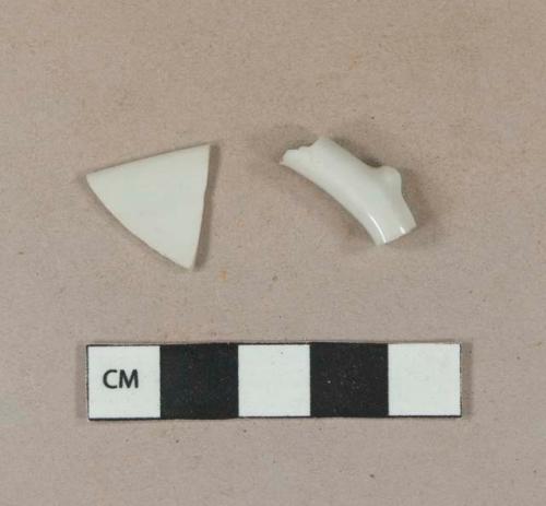 White undecorated porcelain vessel rim and handle fragments, white paste, rim fragment likely formerly gilt