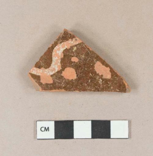 Slip decorated brown leadglazed redware vessel body fragment, slip missing