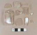 Colorless glass vessel body fragments, likely square bottle fragments, 1 with embossed "[...]& Co[...]"