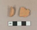 Undecorated unglazed redware vessel body and rim fragments