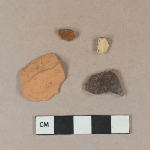 Dark brown lead glazed redware vessel body fragments, 1 redware fragment unglazed; 1 earthenware fragment, unglazed, indeterminate form