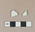 White undecorated porcelain vessel body fragment, white paste; 1 white undecorated ironstone vessel body fragment, white paste