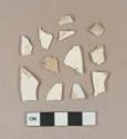 Undecorated creamware vessel body fragments, white or light buff paste; 1 white undecoated pearlware vessel body fragment, white paste; burned refined earthenware vessel fragments