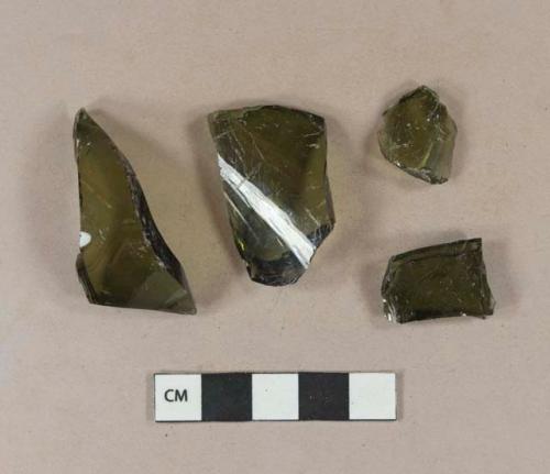 Olive green vessel glass body fragments, likely bottle glass