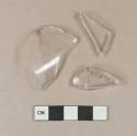 Colorless glass vessel fragments, 1 likely stemware base fragment