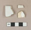White undecorated lead glazed earthenware vessel body fragment, buff paste; White undecorated ironstone vessel rim fragment, white paste; White undecorated salt-glazed stoneware vessel body fragment, light gray paste
