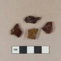 Amber vessel glass body fragments, likely bottle