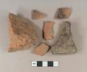 Red brick fragments, 1 burned with mortar residue; Undecorated unglazed redware vessel body fragment, 2 fragments burned