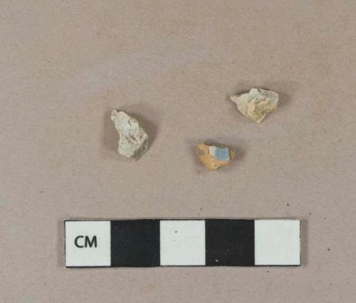 Undecorated tin glaze earthenware body sherds, both crossmend; blue hand painted tin glaze earthenware body sherd