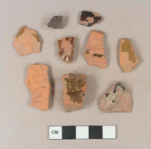 Undecorated lead glazed redware body sherds; undecorated lead glazed redware base sherd; undecorated lead glazed redware rim sherd