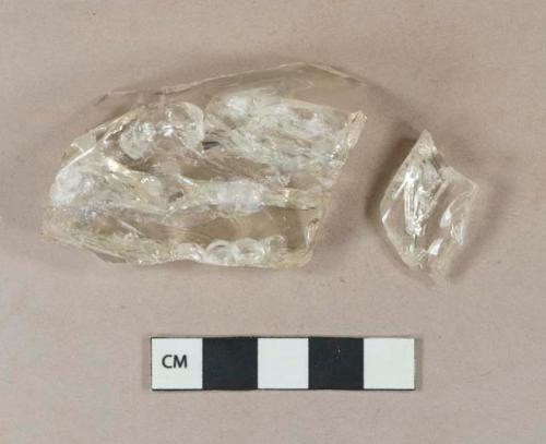 Colorless vessel glass base fragments; two fragments crossmend