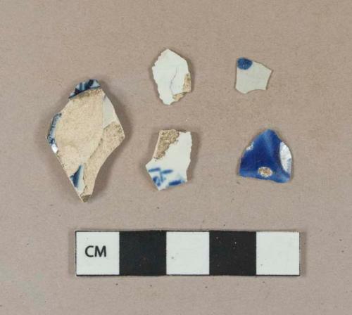 Undecorated pearlware body sherd; blue hand painted pearlware body sherds; flow blue refined earthenware body sherd; blue hand painted tin glazed earthenware body sherd, glaze only