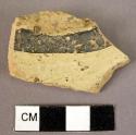Potsherd - lustrous black cracked paint stripe on well baked very gritty ware -