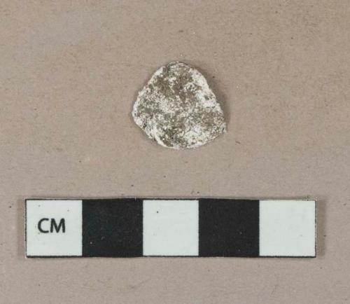 Unidentified white shell fragment, highly degraded