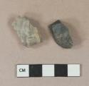 Chipped stone, possibly debitage; one gray fragment, one black fragment