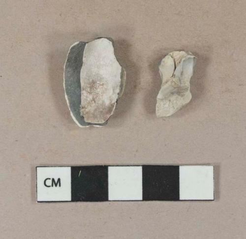 Smoked, undecorated pipe bowl fragments; one has fragment of heel